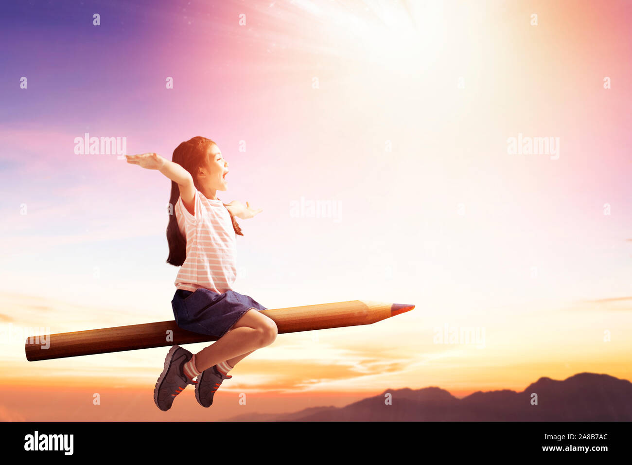 happy little girl on pencil and flying in the sky Stock Photo - Alamy