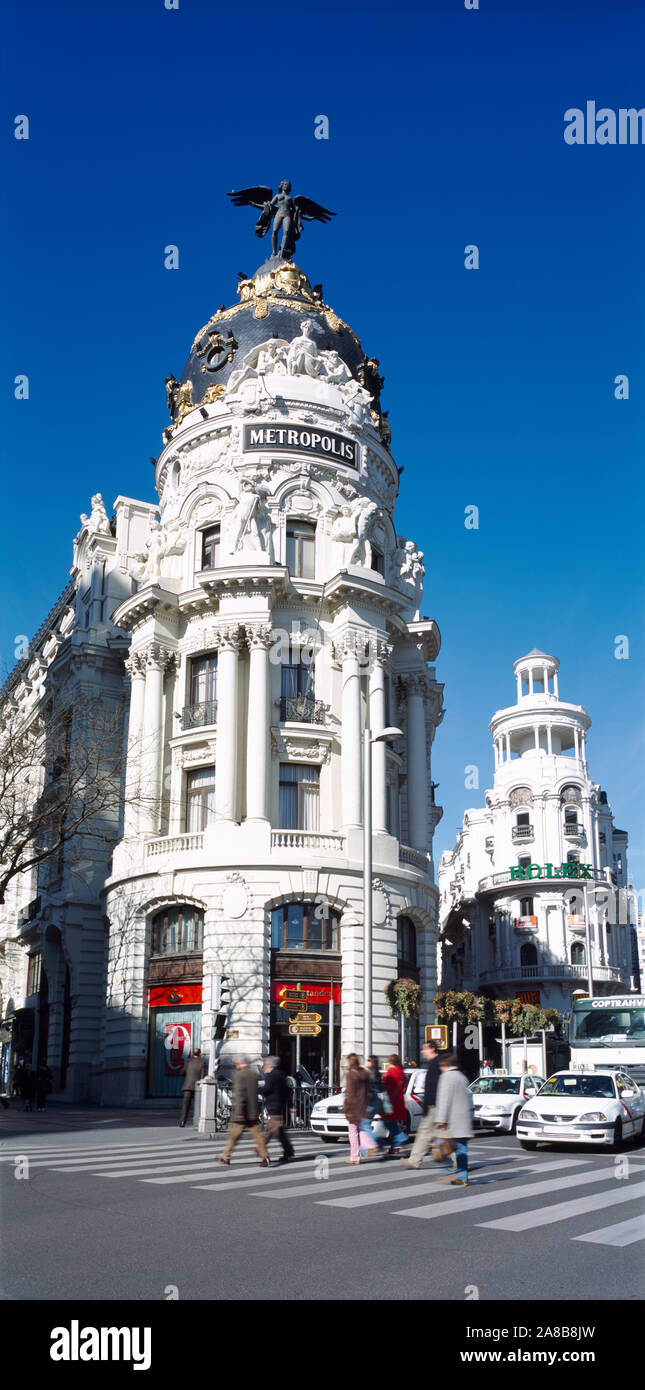 Tourists walking on zebra crossing in front of a building, Metropolis Building, Calle De Alcala, Madrid, Spain Stock Photo
