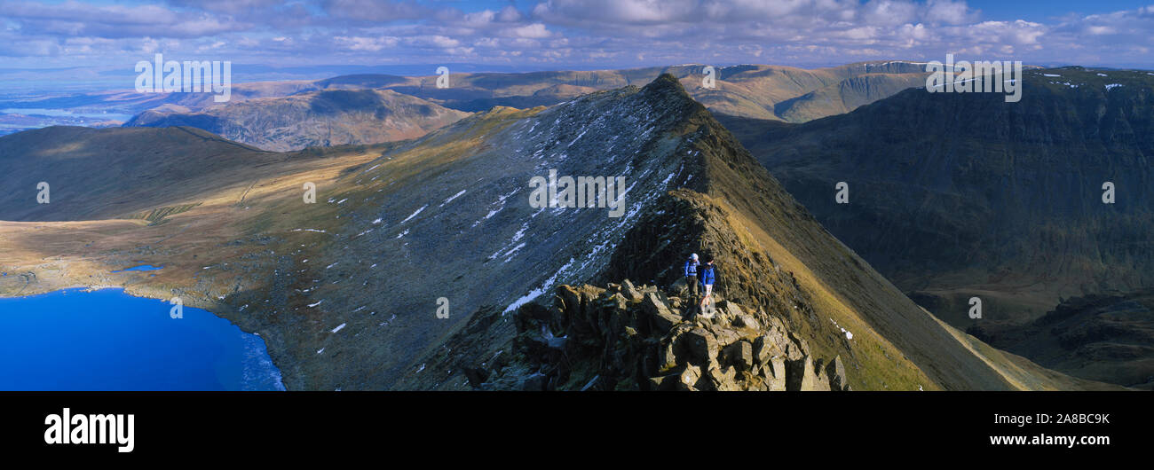 Hikers hiking on a mountain, Striding Edge, Helvellyn, English Lake District, Cumbria, England Stock Photo