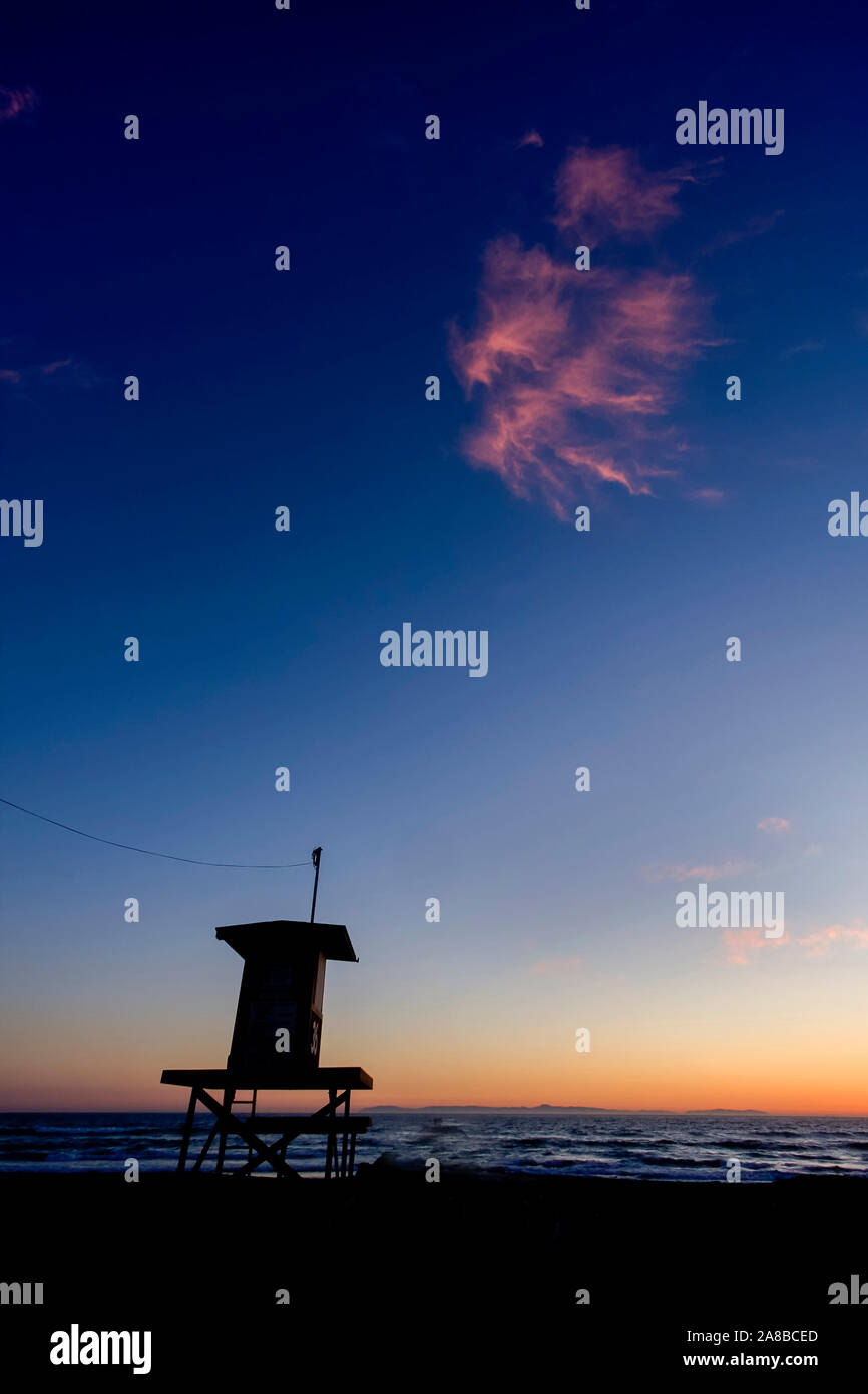 Lifeguard Tower at sunset with pink cloud with negative space taken in Newport Beach Ca Stock Photo