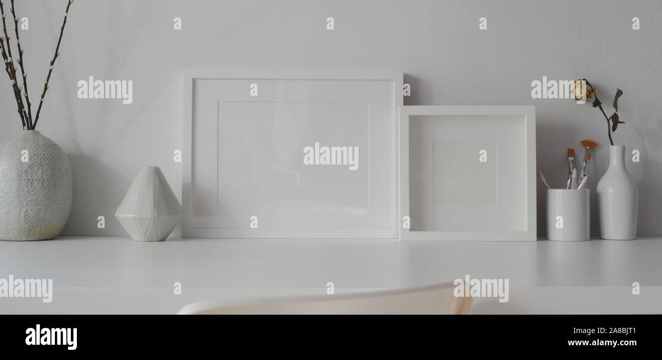 Minimal office room with mock up frames and white ceramic vase ...