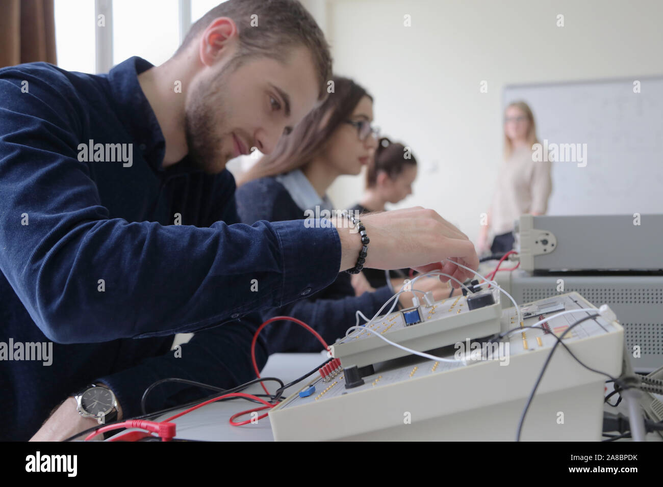 Group of young students in technical vocational training with teacher ...