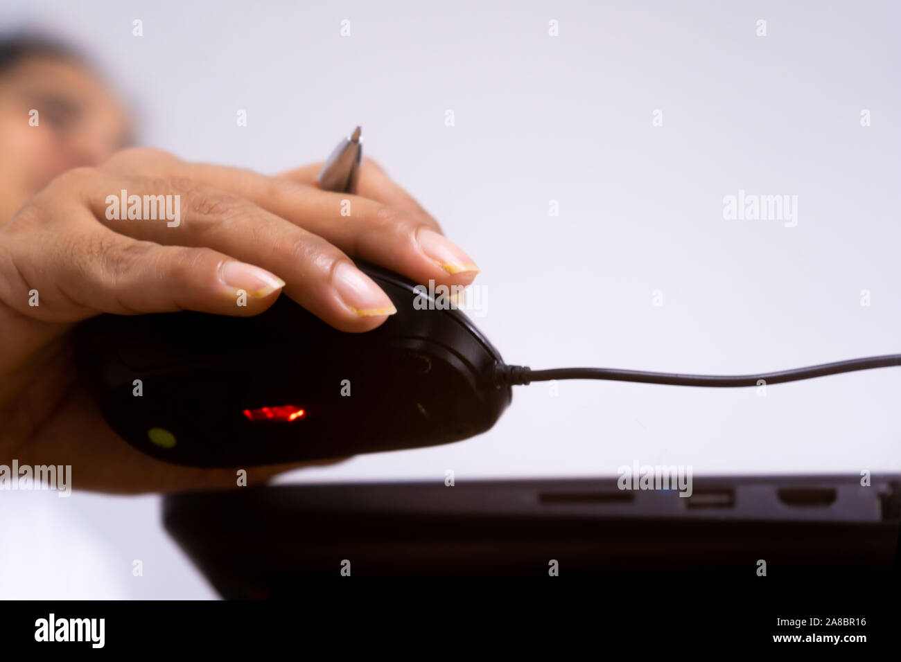Female hand holding computer mouse Stock Photo - Alamy