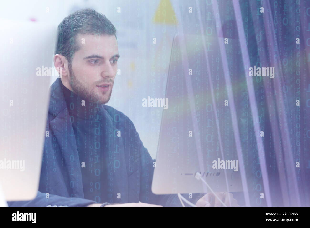 Young male Businessman working on modern computer. Businessman using innovative technologies. Businessman working on computer, software developing wit Stock Photo