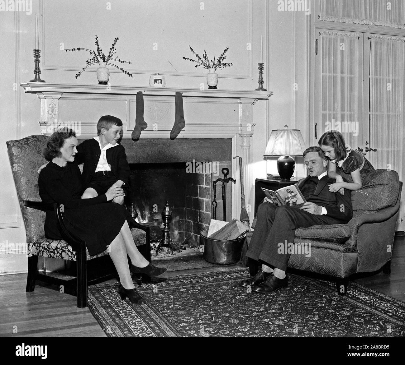 Christmas Eve at home of youngest Supreme Court Justice. Washington, D.C.. Associate Justice of the Supreme Court and Mrs. William O. Douglas with their children December 1939. Stock Photo