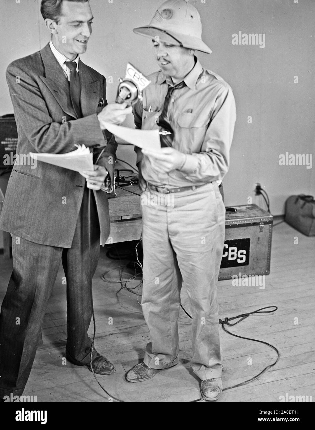 Poston, Arizona. The contractor's Superintendant, Newell, with CBS Announcer, Chet Huntley at the microphone during the broadcast of 'Strange Ports of Call' 5/26/1942 Stock Photo