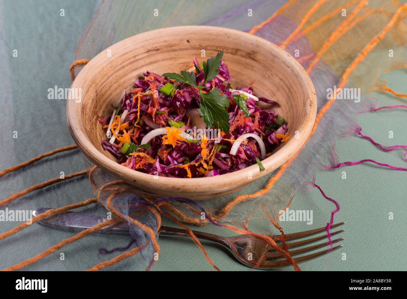 Salad of fresh blue cabbage in a ceramic plate Stock Photo - Alamy