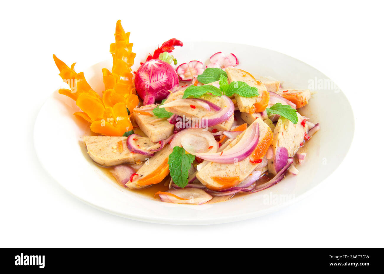 Spicy salad fermented pork sausage with salt egg yolk. Thai food on dish decorate with chili carved  side view Isolated on white background Stock Photo