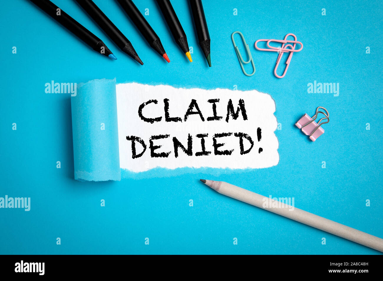 Claim Denied. Indemnification, Insurance and Warranty concept. Text under torn paper Stock Photo