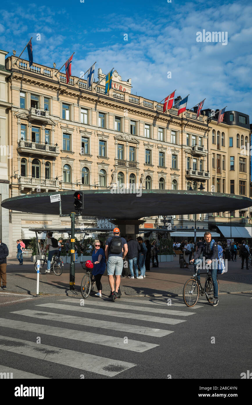 Stockholm Stureplan, view in summer of people passing through the fashionable Stureplan area with its famous mushroom rain shelter, Stockholm, Sweden Stock Photo