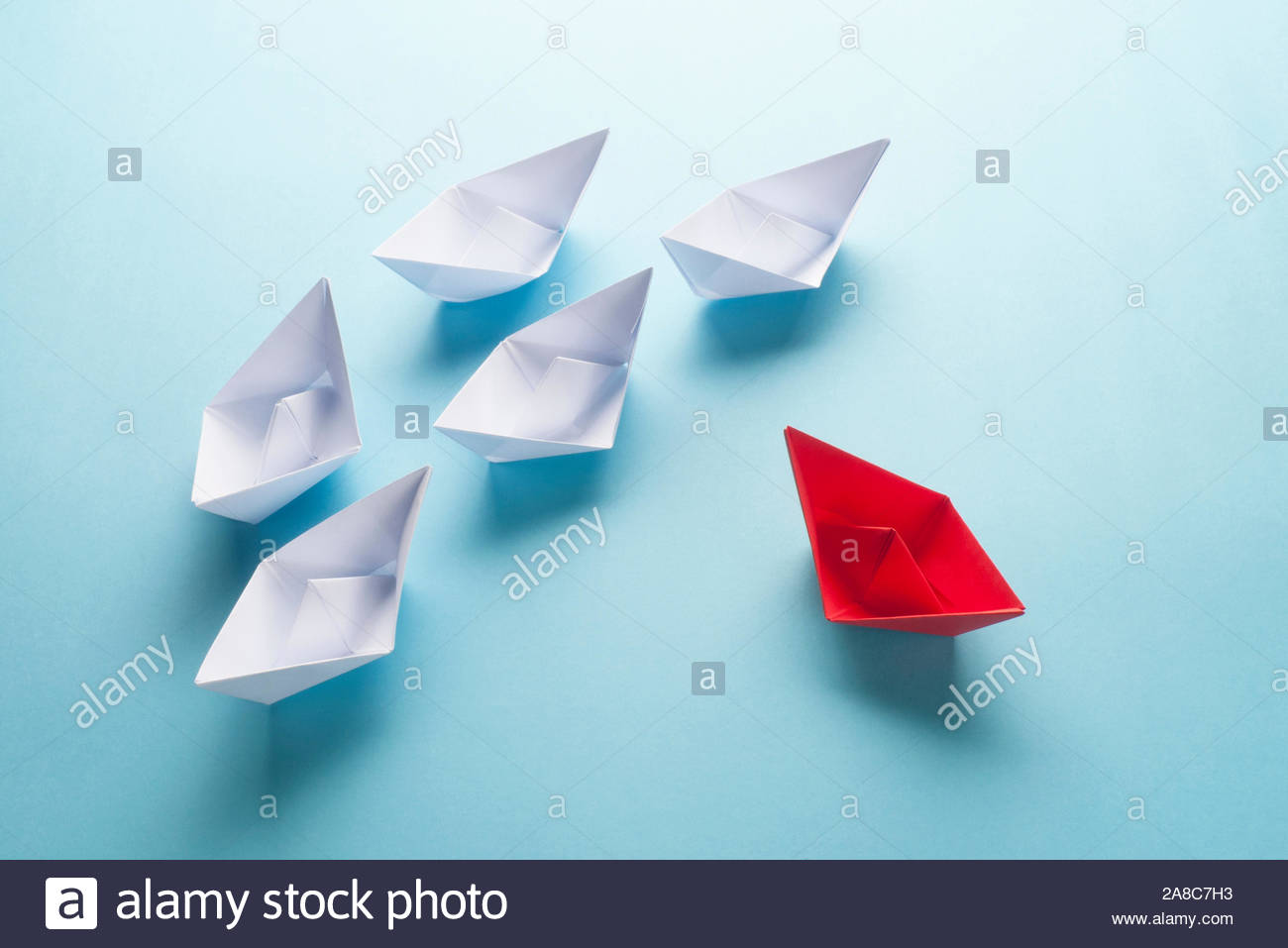 Group Of Origami Boats On Blue One Red Paper Boat With A