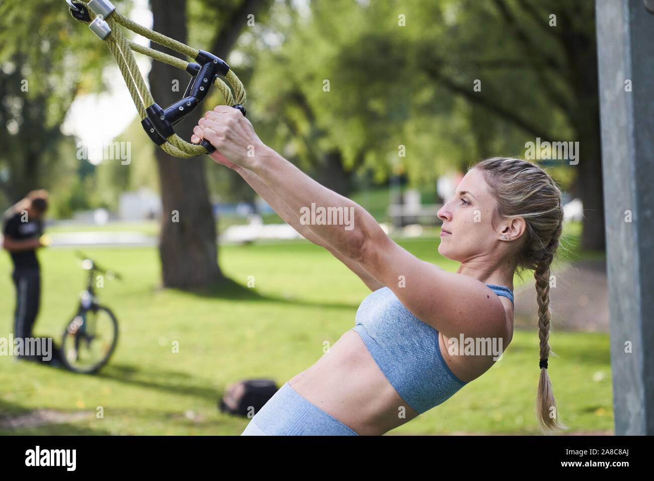 Sporty young woman doing fitness training on the rings, outdoor sports, sporty, Olympiapark, Munich, Germany Stock Photo