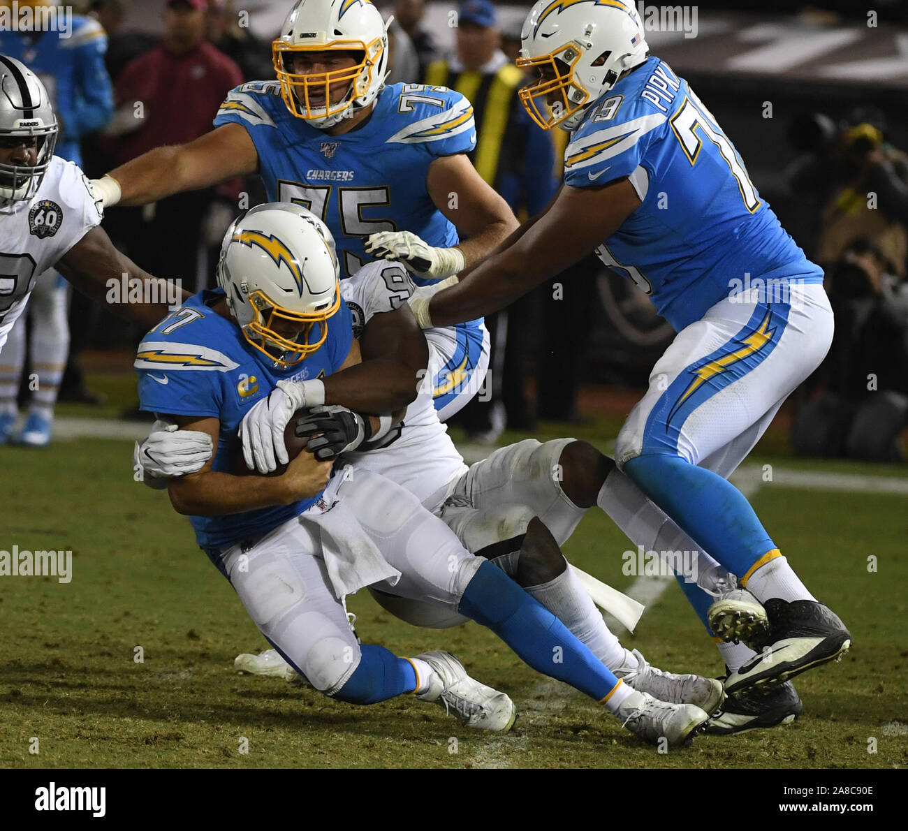 Oakland, United States. 07th Nov, 2019. Los Angeles Chargers quarterback Philip Rivers is sacked for a loss of three yards by Oakland Raiders Clelin Ferrell (96) in the fourth quarter quarter at the Alameda County Coliseum in Oakland, California on Thursday, November 7, 2019. The Raiders defeated the Chargers 26-24. Photo by Terry Schmitt/UPI Credit: UPI/Alamy Live News Stock Photo