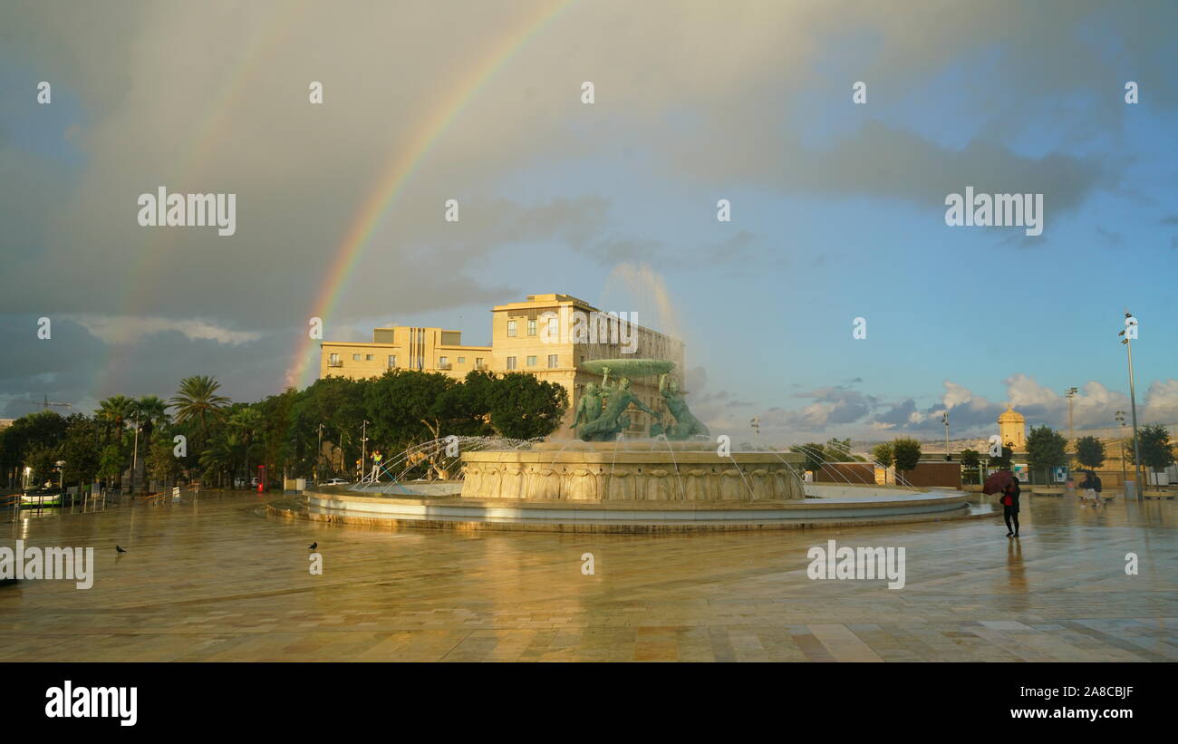 The Triton fountain, in La Valletta, Malta, with rainbow Stock Photo