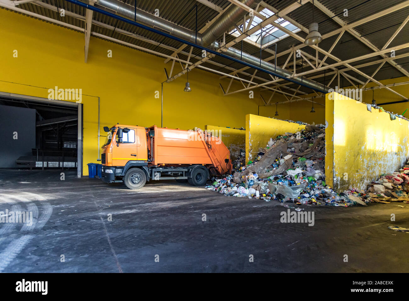 truck throws garbage at sorting modern waste recycling processing plant. Separate and sorting