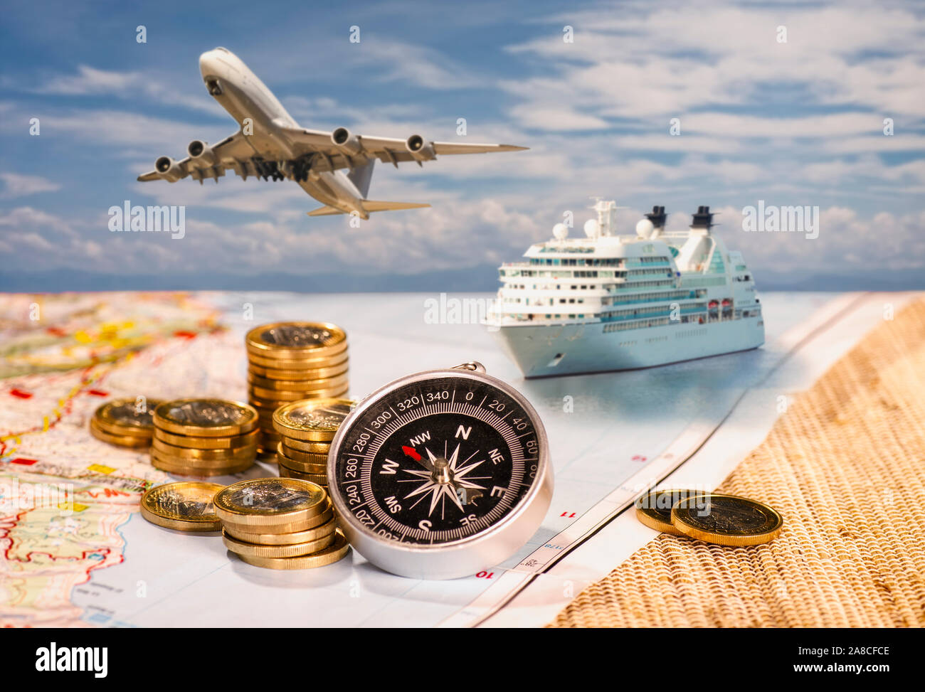 Airplane And Cruise Ship With Compass And Coins On A Map Stock Photo Alamy
