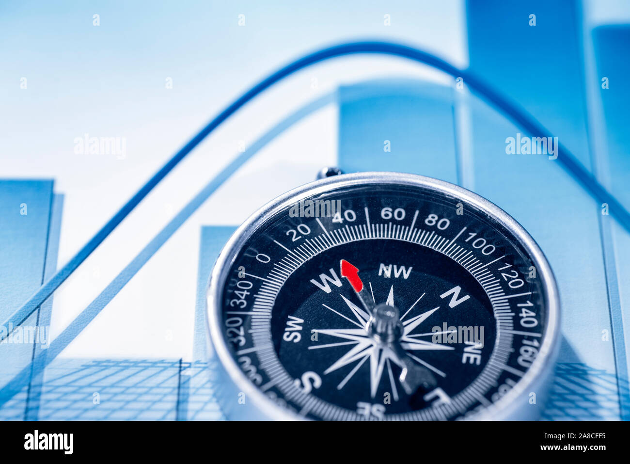 Chart with price curves and a compass for orientation Stock Photo