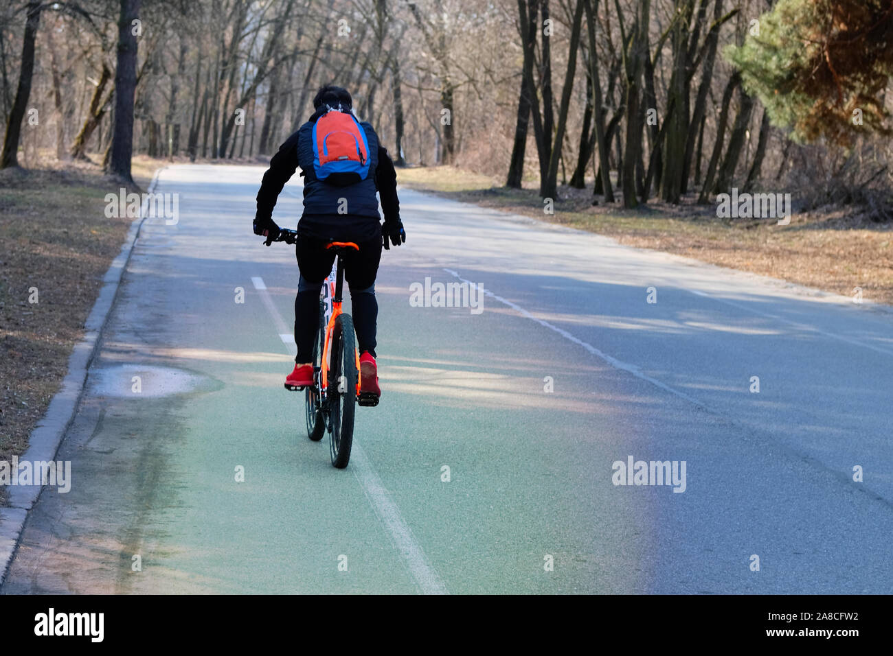 Man is riding on bicycle in a park. Ride for exercise and relaxation. Healthy lifestyle. Sport and active life concept. Stock Photo