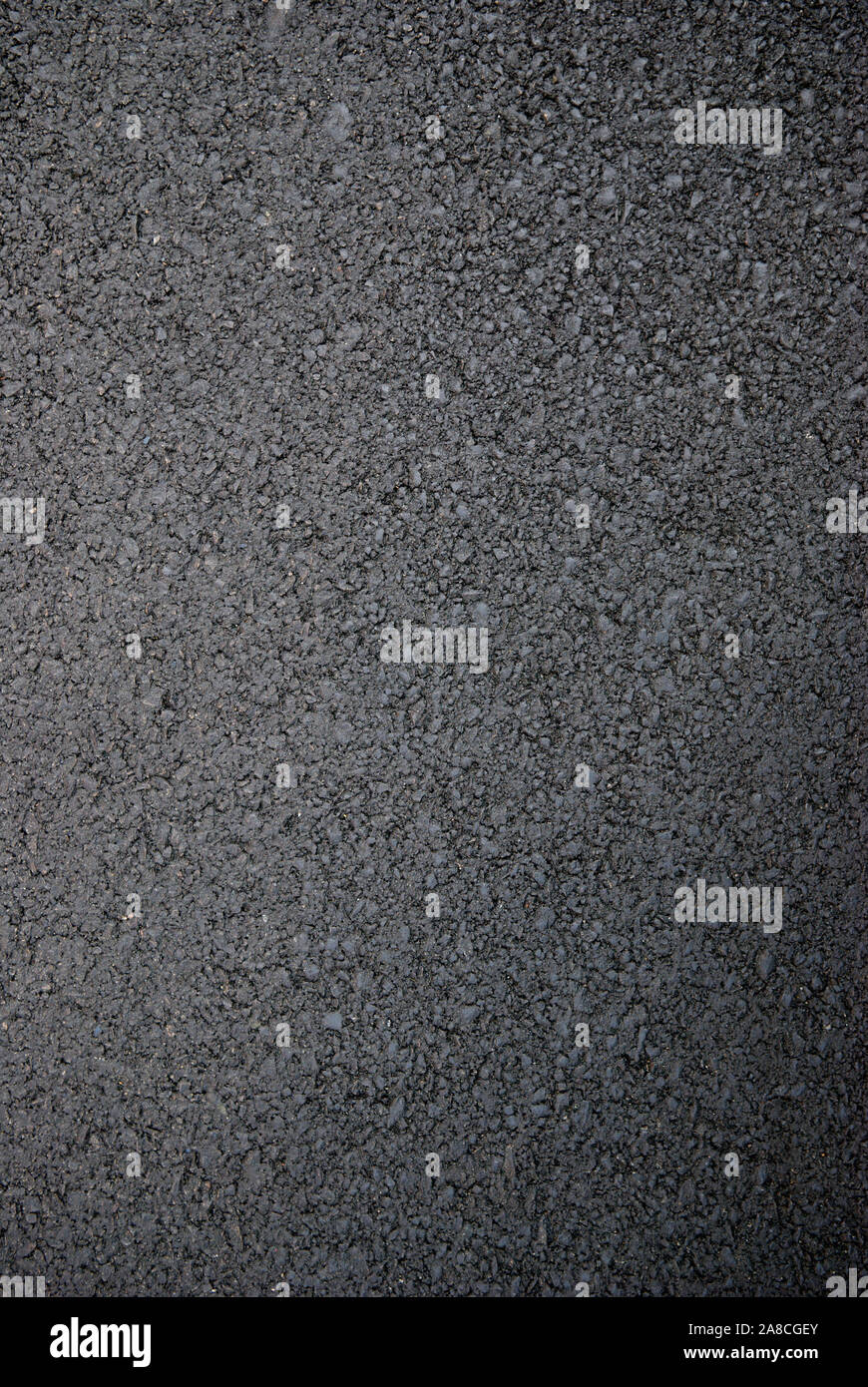 Smooth, dark, new asphalt in a full frame close-up background Stock Photo