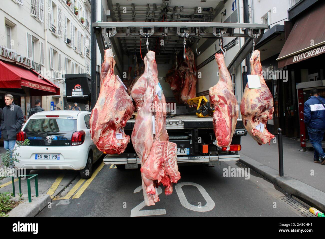 animal carcasses hanging from the back of lorry paris france Stock Photo