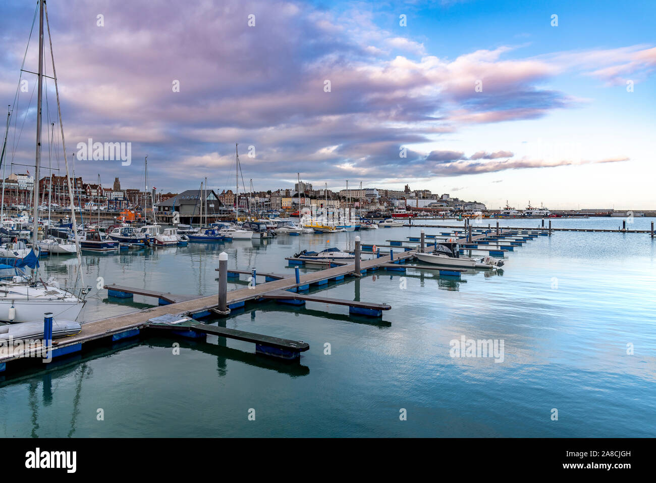 Late evening at Ramsgate harbour. With fishing boats, yachts, little boats and speed boats. Deep blue skies and reflections on the sea. Stock Photo