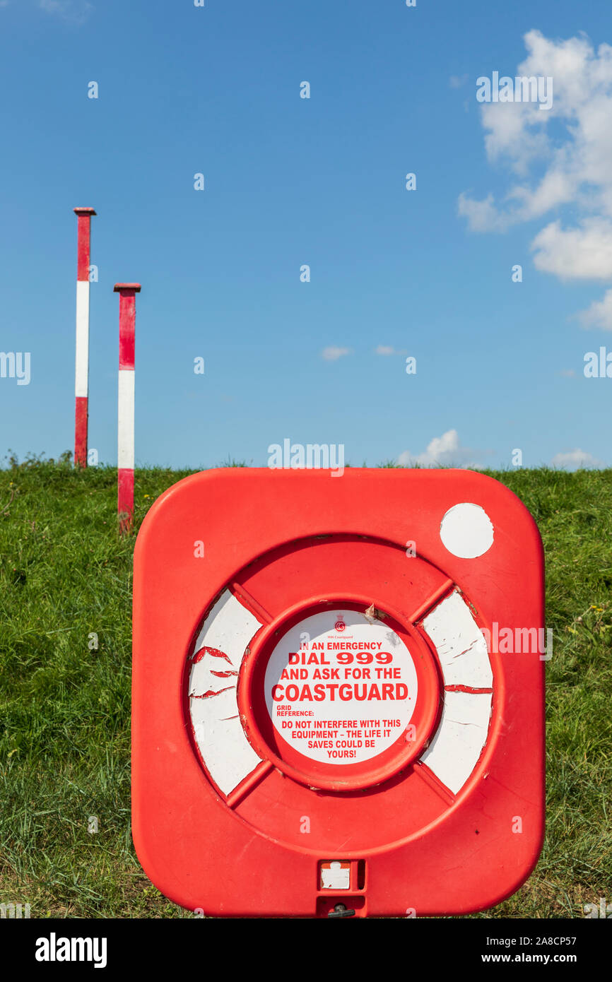 An emergency lifebelt buoyancy ring displaying the message dial 999 and ask for the coastguard. Stock Photo