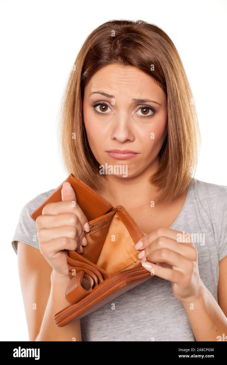 sad woman shows her empty wallet Stock Photo