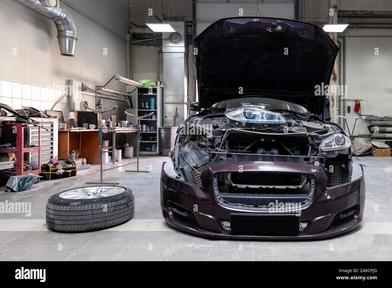 The brown car in the body of the sedan is preparing for painting the