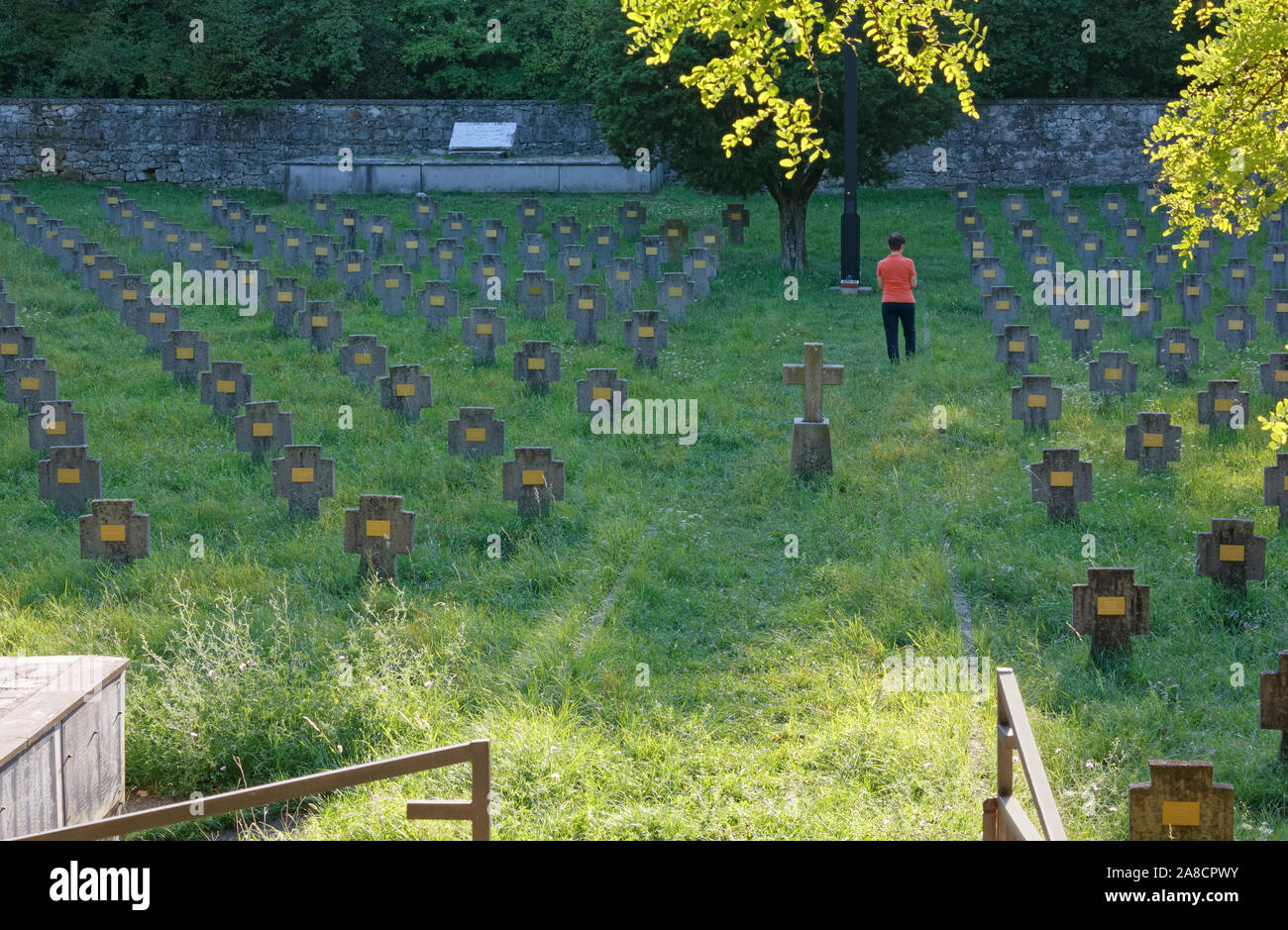 Woman visiting the Austro-Hungarian military cemetery of Prosecco-Prosek, on the Karst plateau next to Trieste Stock Photo