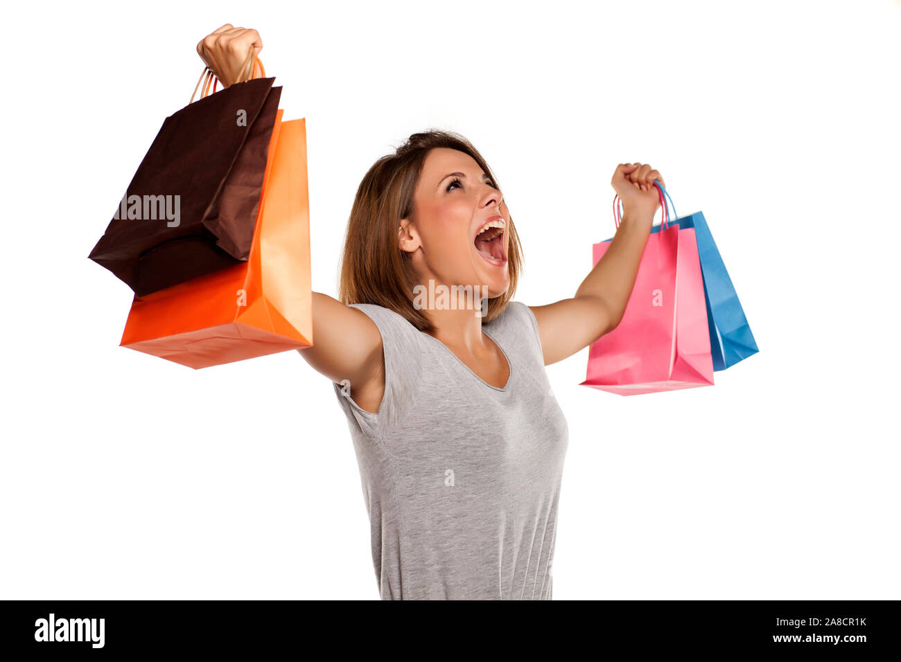 happy woman posing with shopping bags on a white background Stock Photo ...