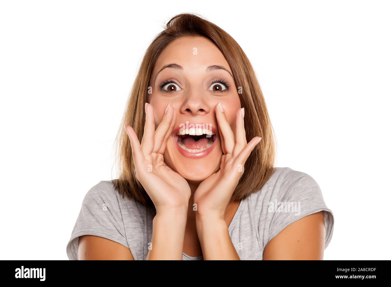 happy woman yelling with hands next to the mouth Stock Photo