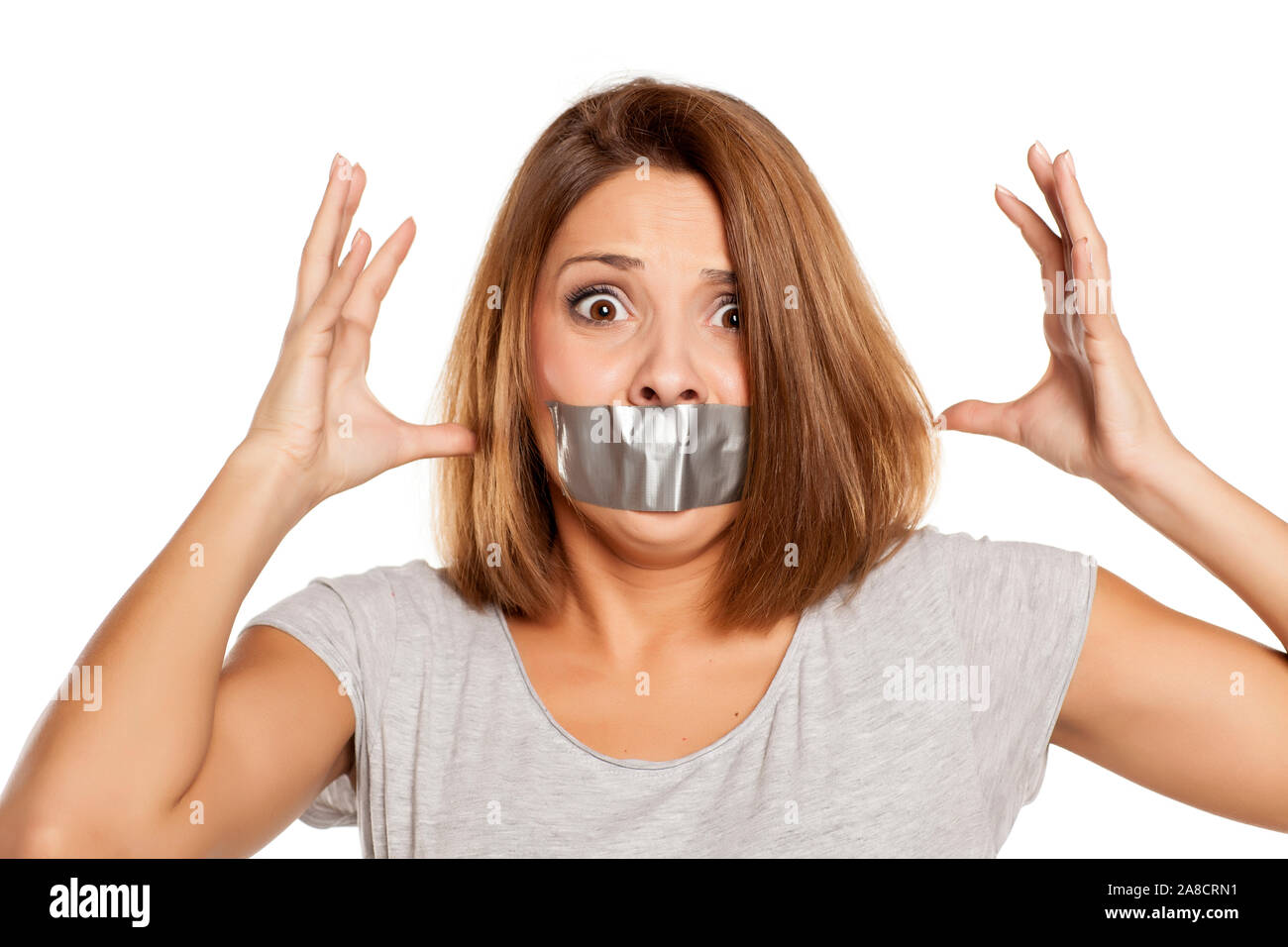 nervous young woman with adhesive tape over her mouth Stock Photo
