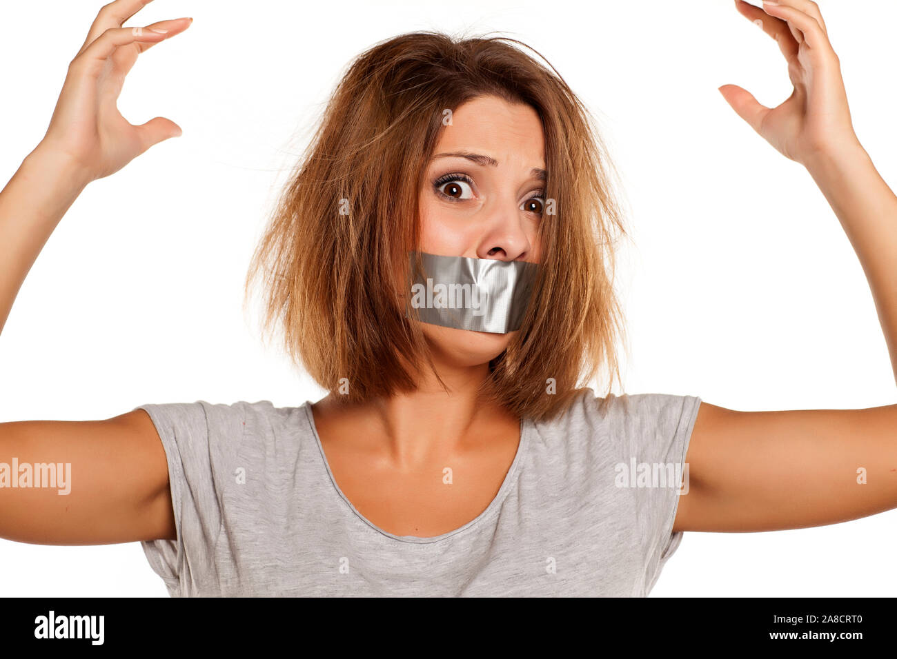 nervous young woman with adhesive tape over her mouth Stock Photo