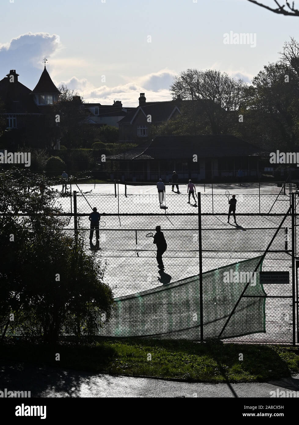 Brighton UK 8th November 2019 - Tennis players make the most of a beautiful sunny Autumn morning in Queens Park Brighton as other parts of Britain experience heavy rain and floods particularly in the north. Credit: Simon Dack / Alamy Live News Stock Photo