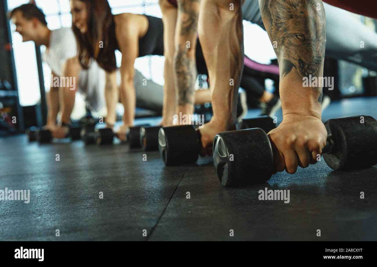 A group of muscular athletes doing workout at the gym. Gymnastics