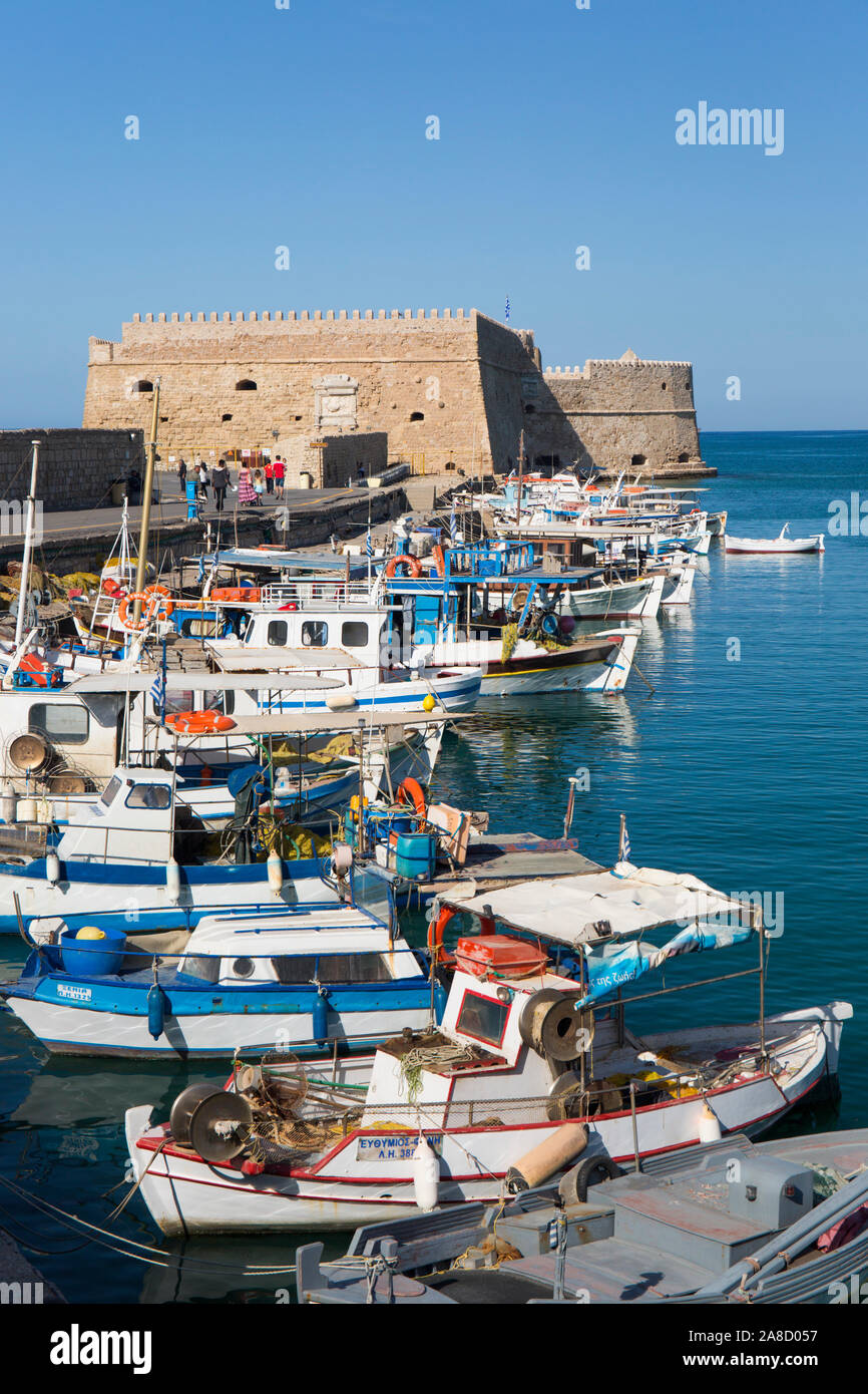 Heraklion, Crete, Greece. View across the Venetian Harbour, boats moored in front of the Koules Fortress. Stock Photo