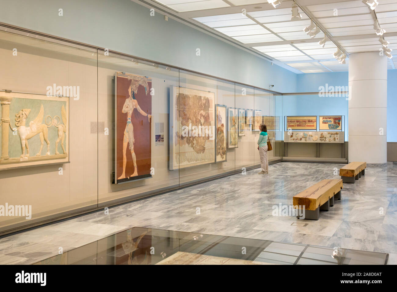Heraklion, Crete, Greece. Visitor looking at Minoan frescoes on display in the Heraklion Archaeological Museum. Stock Photo