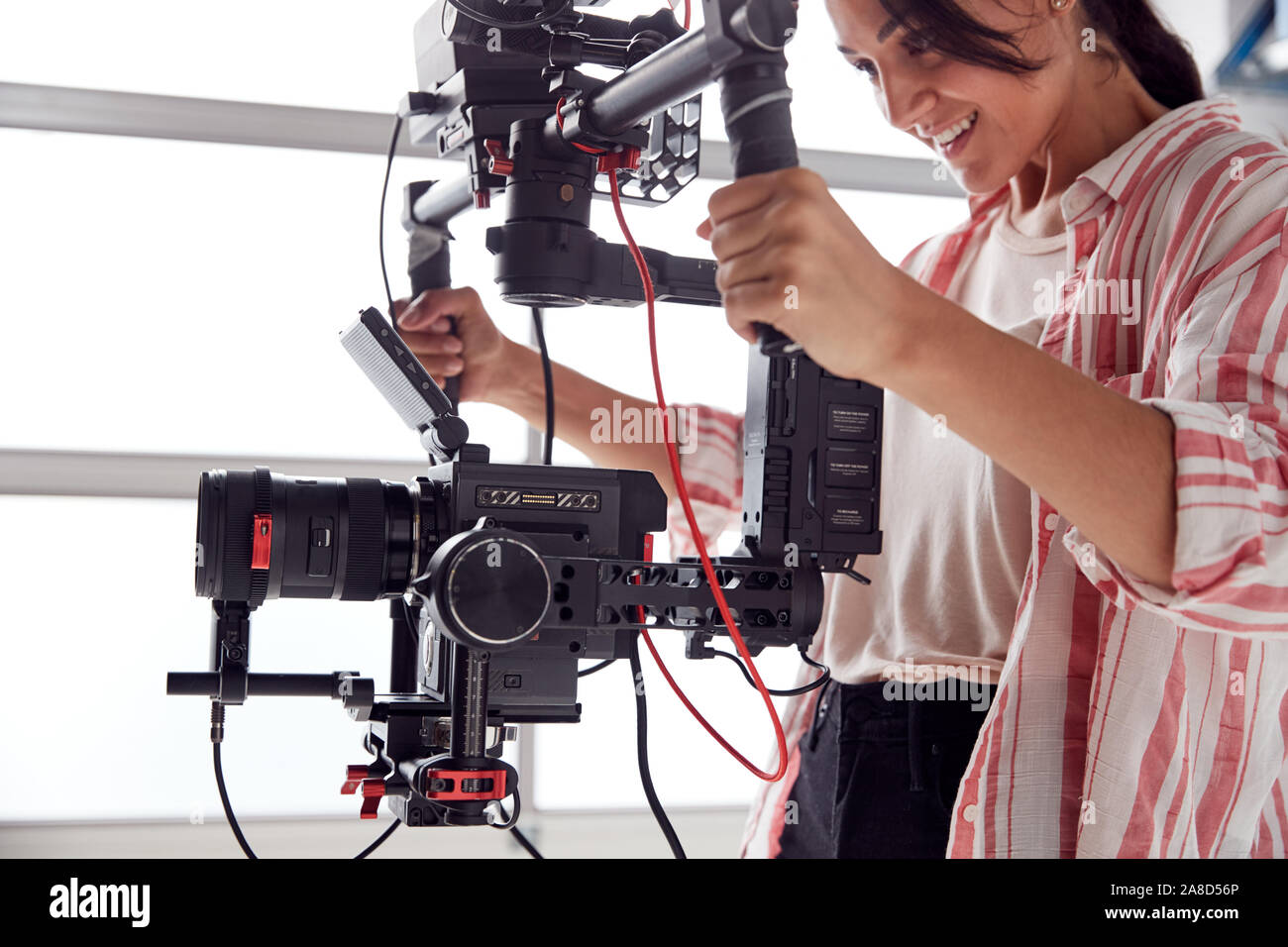 Videographer Rigs Female Videographer With Video Camera On Steady Cam Rig Filming Movie ...