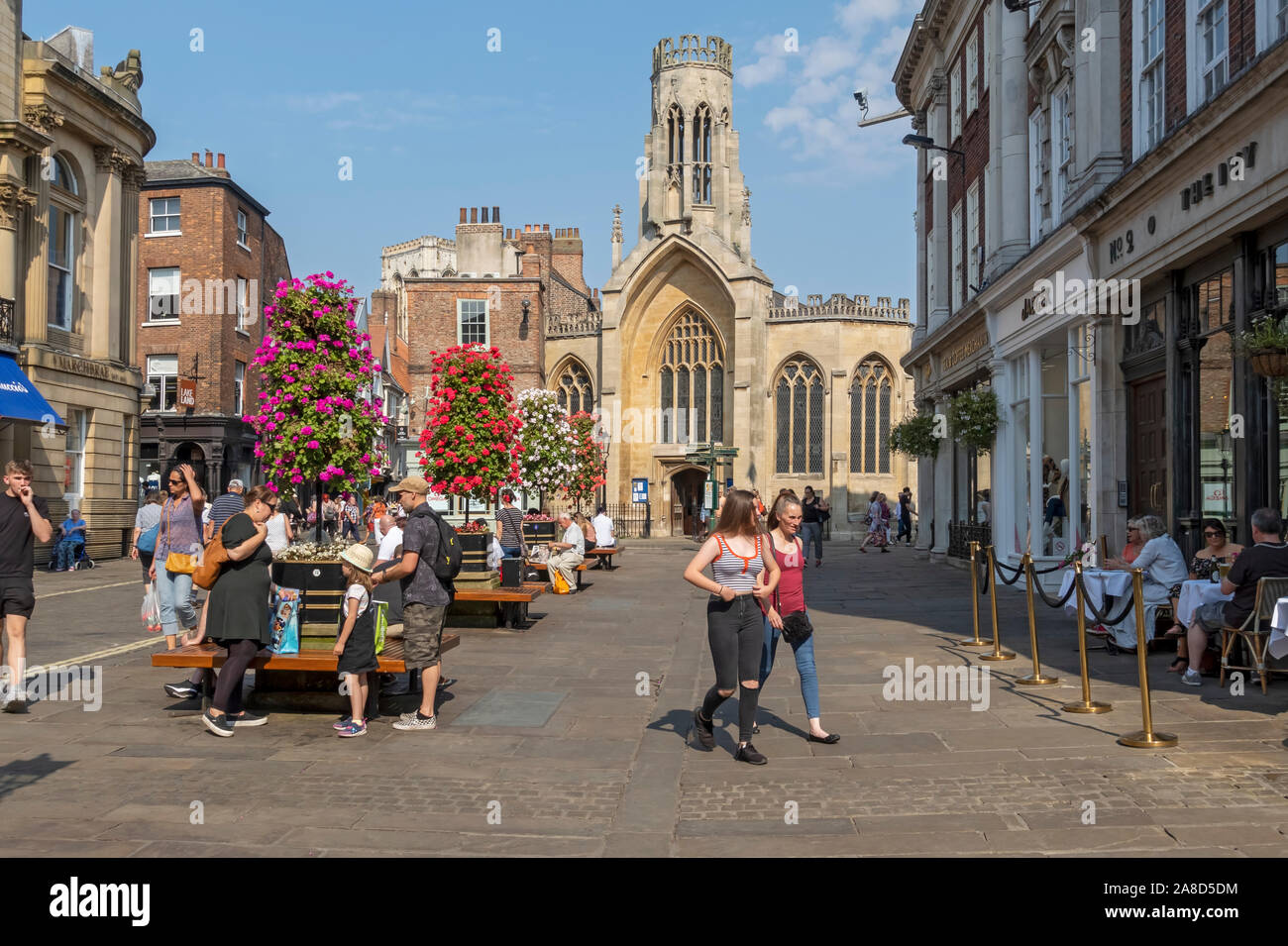 People tourists visitors in St Helen's Square in summer York city centre North Yorkshire England UK United Kingdom GB Great Britain Stock Photo