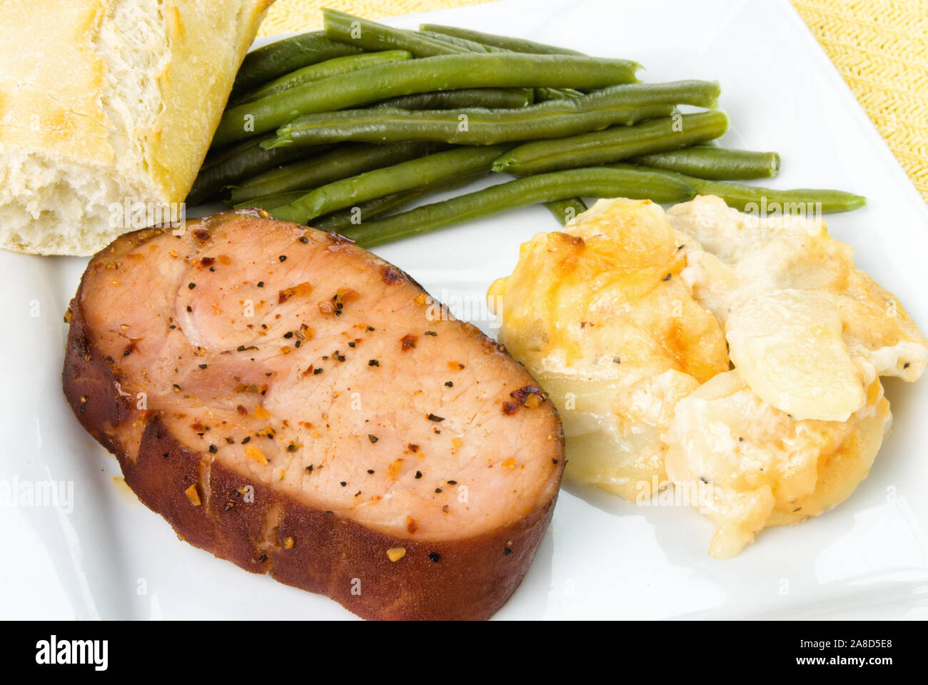 Smoked boneless pork chop holiday meal served with green beans and