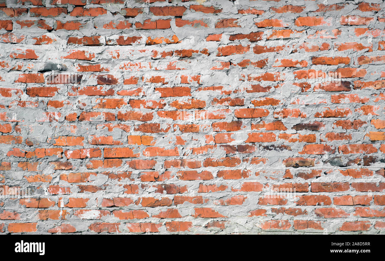 Red brick wall with rough cement mortar. Background. Stock Photo