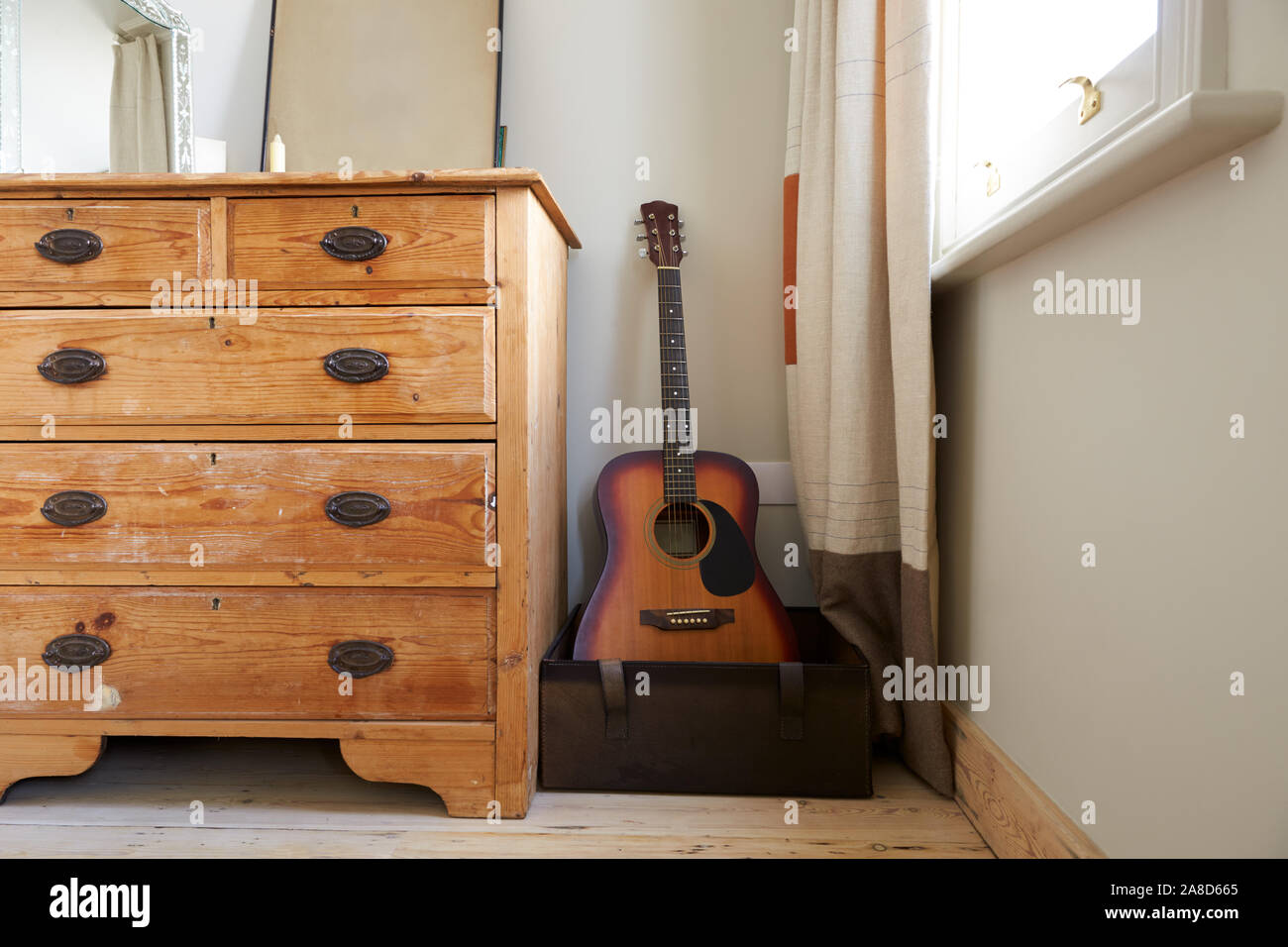 Room Interior With Chest Of Drawers And Acoustic Guitar In