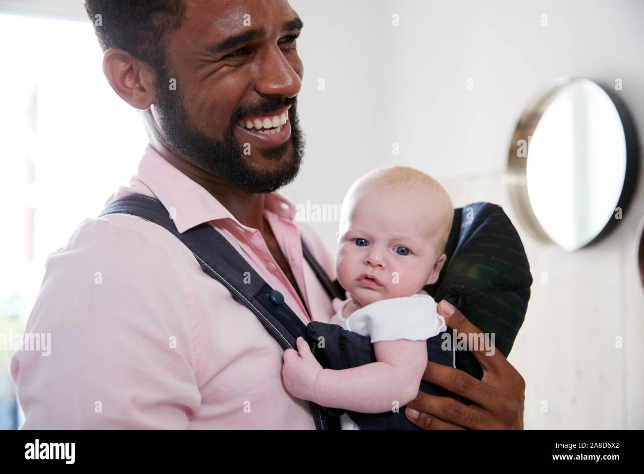 Man carrying cheap baby in sling