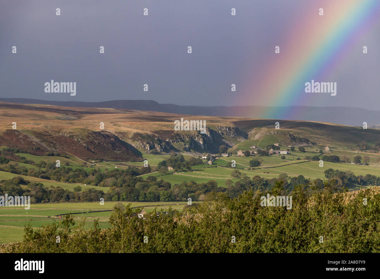 A vivid rainbow and dark sky at Holwick, Teesdale Stock Photo