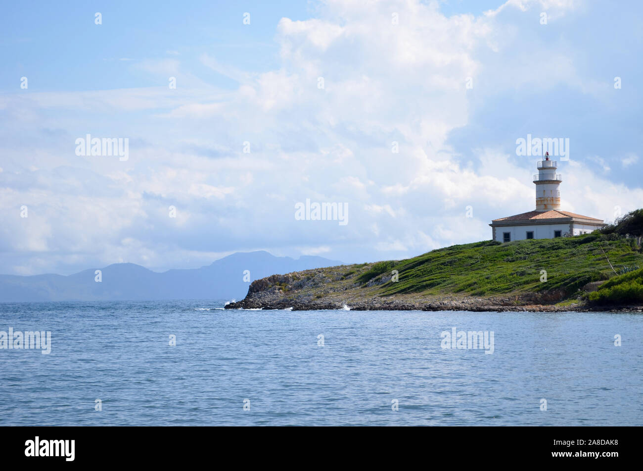 Alcanada lighthouse in the bay of Alcudia in Mallorca. Stock Photo