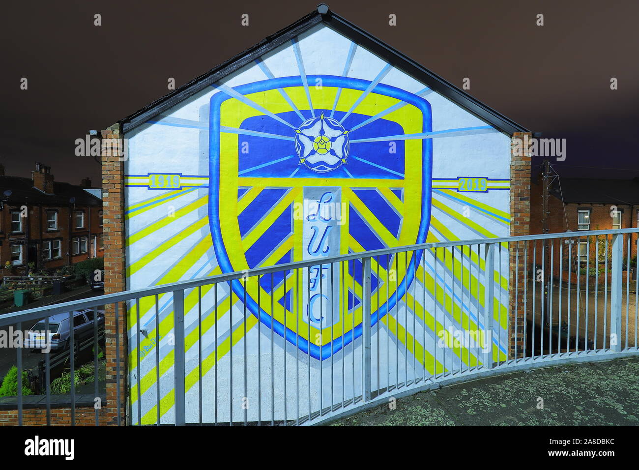 A  giant mural has been painted onto the end of a row of back to back terraced houses in Leeds to mark 100 years of Leeds United Football Club. Stock Photo