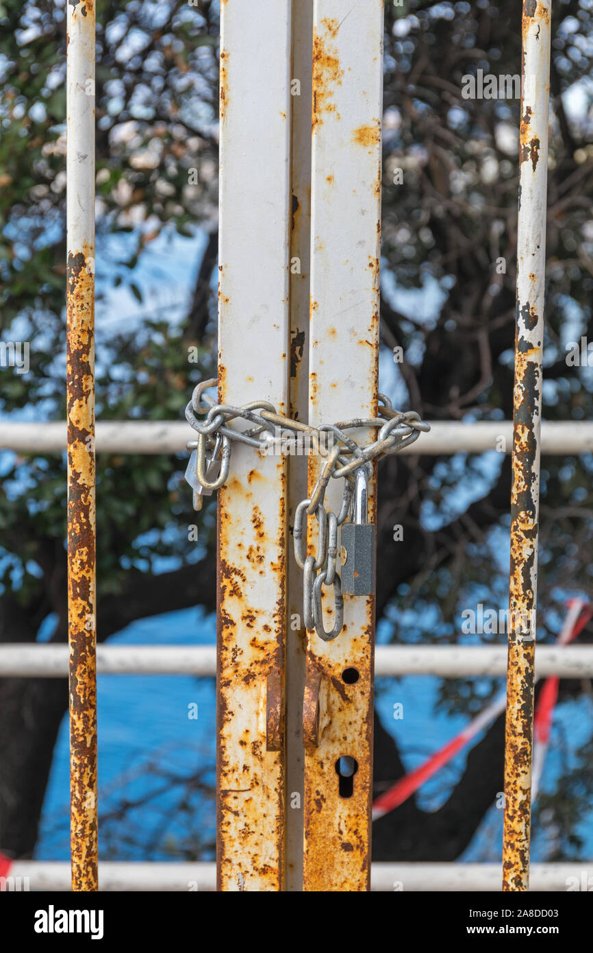 Padlock and Chain at Locked Metal Gate Stock Photo