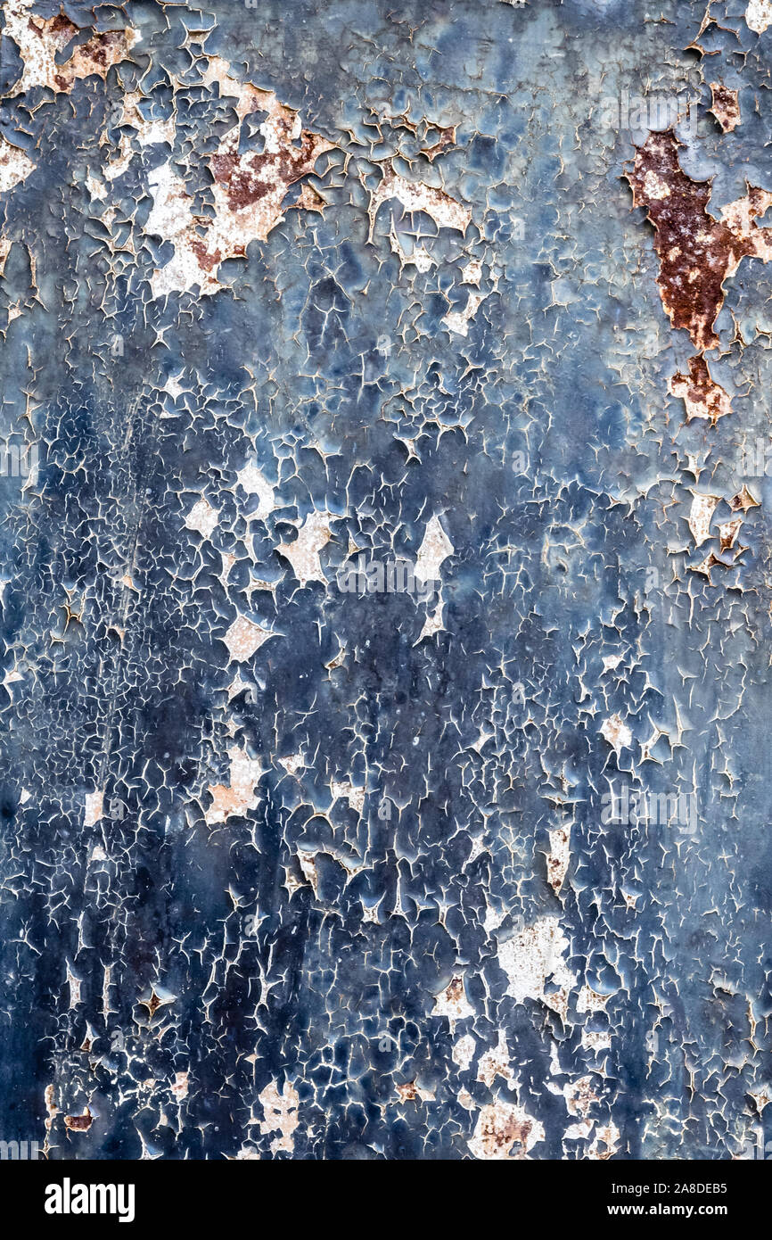 Rusty metal with blue paint flaking off to use as background Stock Photo