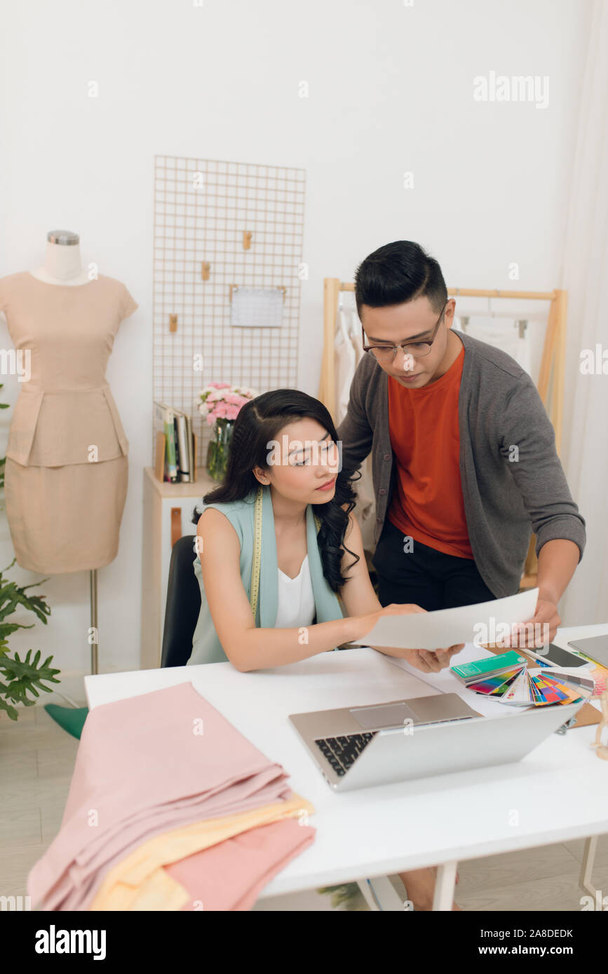 Two fashion designers working together on a desk Stock Photo