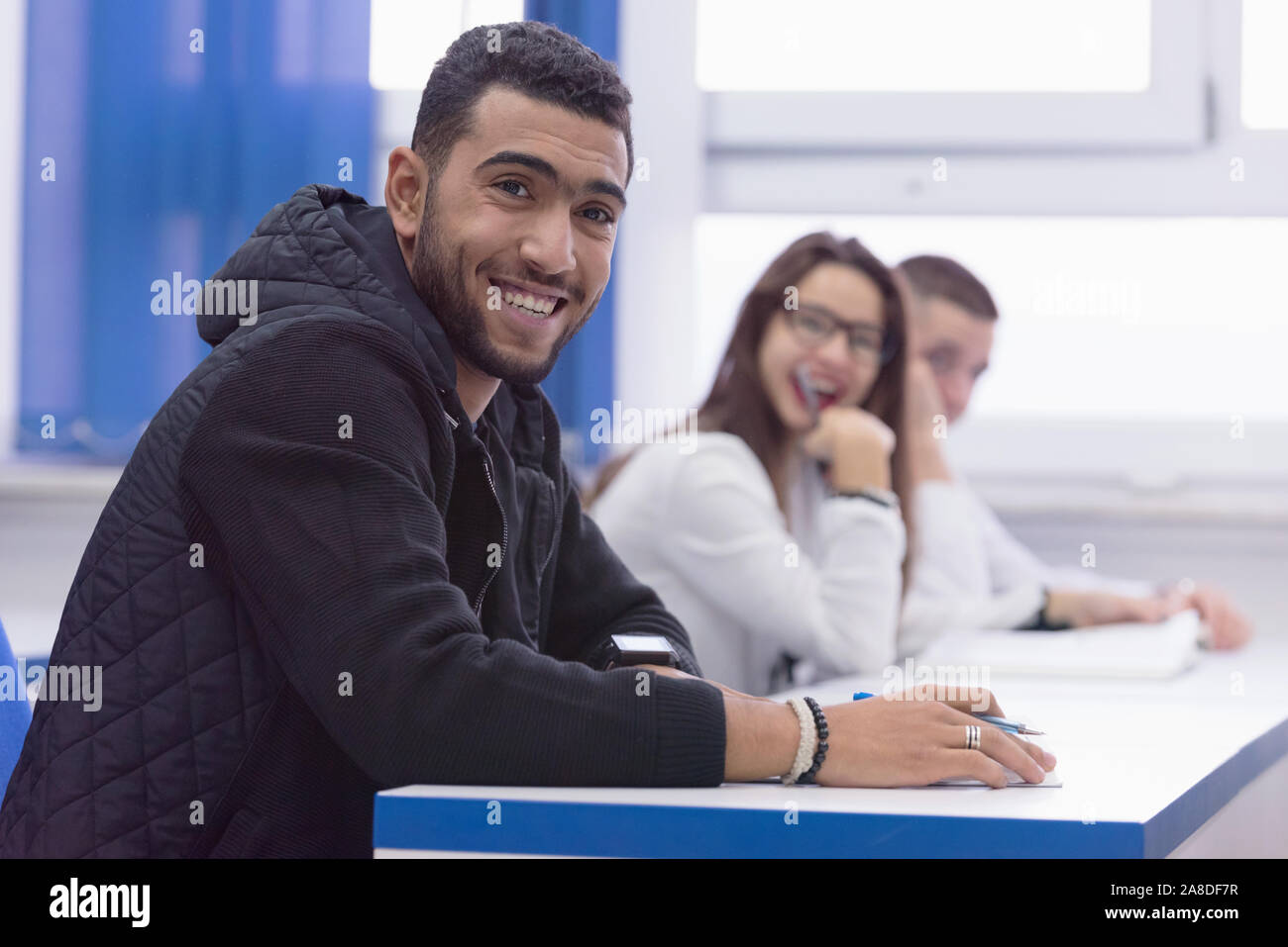 Smiling African American University Male Student In Class Sits At